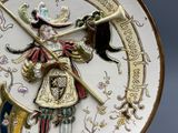 a decorative plate with a picture of a man holding a sword