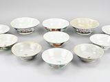 eight chinese porcelain bowls and a bowl on a white surface
