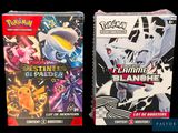 two boxes of pokemon card games sitting on top of each other