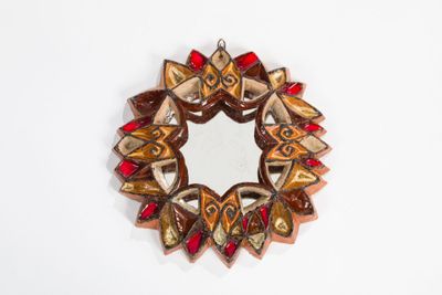 a picture of a decorative mirror on a white wall