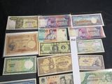 several different types of foreign currency laid out on a table