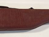 an old brown leather case sitting on top of a white table