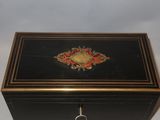 a black box with a gold and red design on it