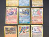 the pokemon cards are lined up on a black surface