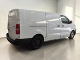 the back of a white van parked in a large room