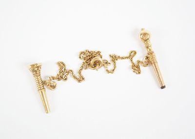 a close up of a pair of gold earrings on a white surface