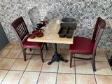 a small table with two chairs and a bowl on it