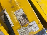 a close up of a yellow machine with a black handle