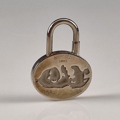 a silver padlock with a picture of two cats on it