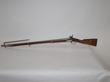 a rifle with a wooden barrel on a white surface