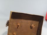 a small wooden box with holes in it on a table