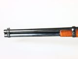 an old shotgun with a wooden handle on a white background