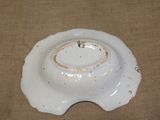 a white plate with a hole in the middle of it