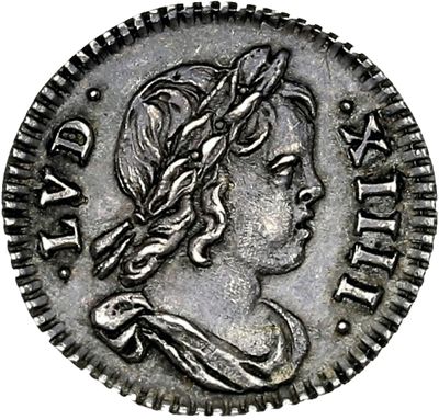 a silver coin with a woman ' s head on it