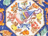 a decorative plate with a bird on it on a table