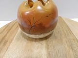 a small vase that is sitting on top of a wooden table