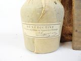 a bottle with a label on it next to a wooden box