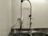 a kitchen sink with a faucet and a faucet attached to the faucet