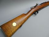 a rifle with a wooden barrel and brass plated sights