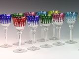 many different colored wine glasses lined up in a row