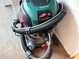 a vacuum that is sitting on the floor next to a wall