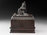 an image of a statue of a woman sitting on top of a wooden box