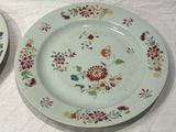 two plates with flowers on them on a table