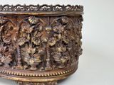 a large metal bowl with carvings on it on a white surface