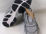 pair of gray and black running shoes on a white surface