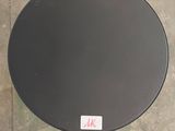 a black toilet seat with a sticker on it