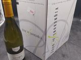 a bottle of wine sitting next to a box of wine