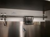 a metal shelf with a bunch of utensils hanging from it