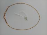 a close up of a gold chain with a tag on it