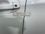 a measuring tape on the door handle of a car