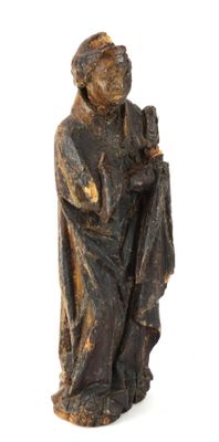 une vieille statue représentant un homme tenant une bouteille de vin
