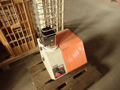 a blender sitting on top of a pallet in a warehouse