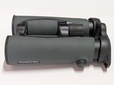 an image of a close up of a pair of binoculars on a white surface