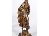 a bronze statue of a woman with a crown on her head