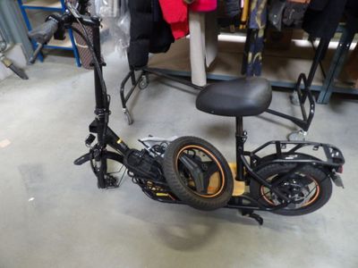 a scooter that is sitting on the floor in a room