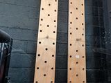 two wooden pegs on the wall of a room