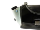 a black and white purse sitting on a white surface
