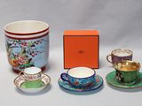 four cups and saucers sitting next to each other