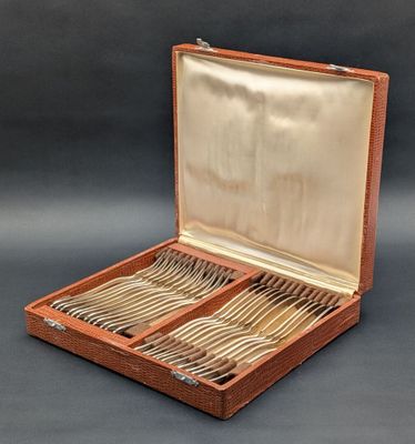 a wooden box with silverware in it on a table