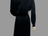 an image of a mannequin wearing a black dress and black shoes
