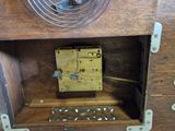 a clock that is sitting in a wooden box
