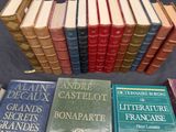 several books are stacked on top of each other on a table