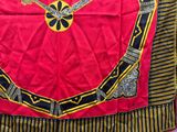 a red and black table cloth with a gold design on it