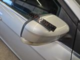 a remote control attached to the side mirror of a car