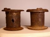 two spools sitting on top of a wooden table