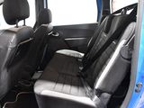 the back seats of a blue car with black trims and a black seat belt